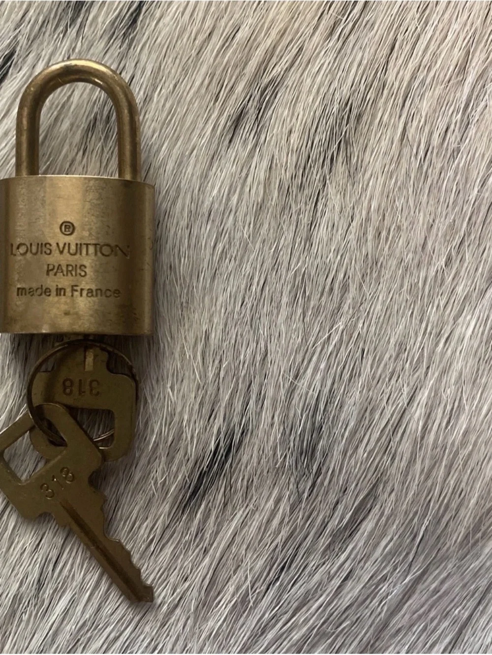 LOUIS VUITTON BRASS LOCK AND KEY SET.